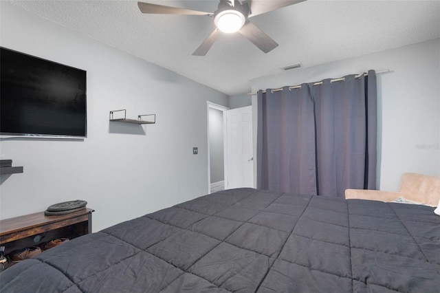 unfurnished bedroom featuring ceiling fan and a textured ceiling