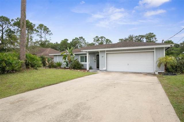 ranch-style home featuring a front lawn and a garage