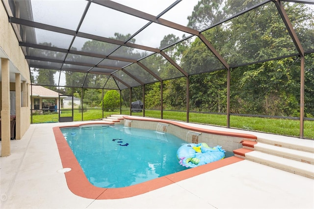 view of swimming pool featuring pool water feature, a patio area, a lanai, and a lawn