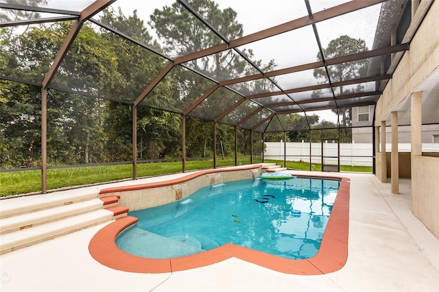 view of swimming pool with glass enclosure and a patio