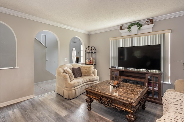 living room with a textured ceiling, hardwood / wood-style flooring, and ornamental molding