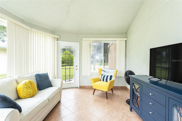 interior space with light tile patterned floors and vaulted ceiling