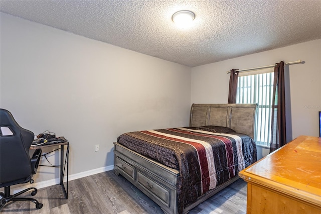 bedroom with wood-type flooring and a textured ceiling