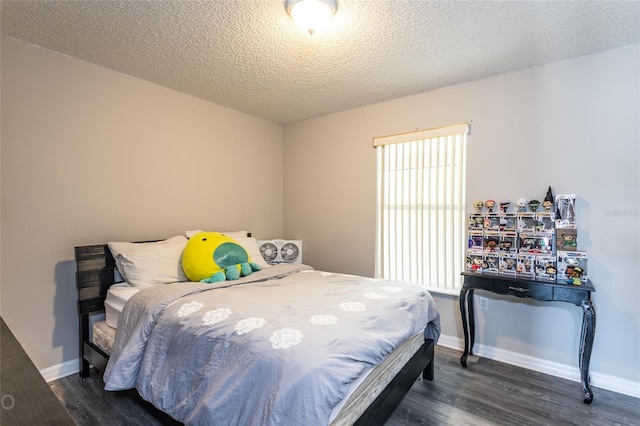 bedroom featuring dark hardwood / wood-style flooring and a textured ceiling