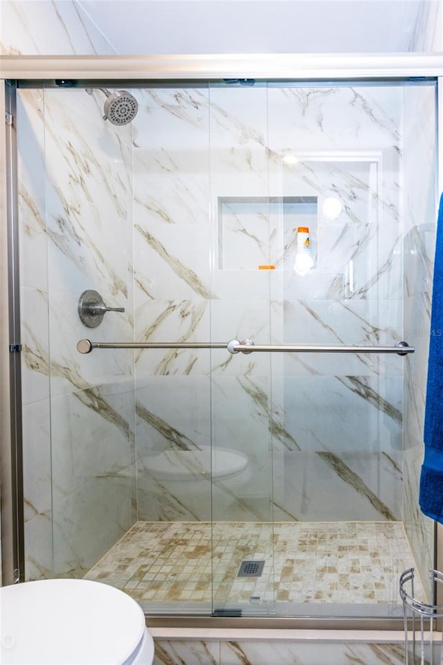 bathroom featuring toilet and walk in shower