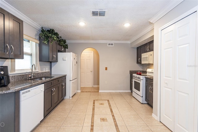 kitchen with dark brown cabinets, crown molding, sink, and white appliances