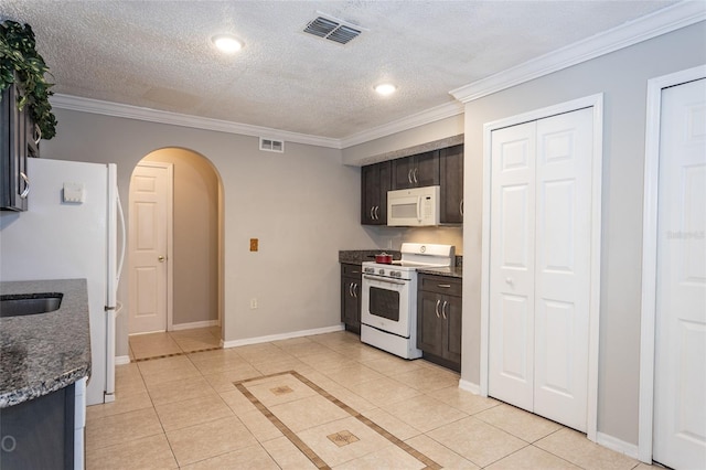 kitchen with a textured ceiling, dark brown cabinets, white appliances, and ornamental molding