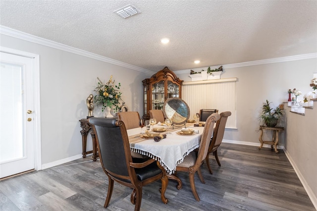 dining space with a textured ceiling, dark hardwood / wood-style floors, and ornamental molding