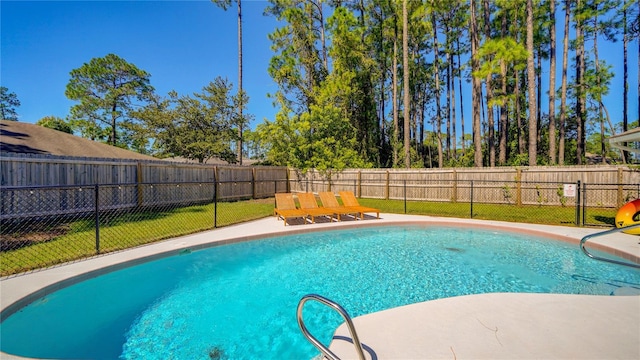 view of pool with a yard