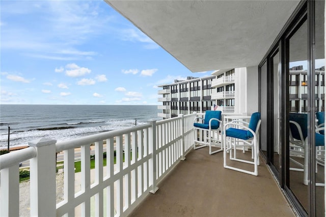 balcony with a beach view and a water view