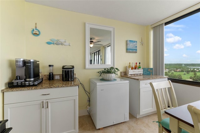 laundry room with light tile patterned floors and ceiling fan