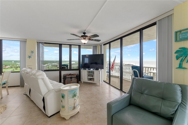 tiled living room featuring floor to ceiling windows and ceiling fan