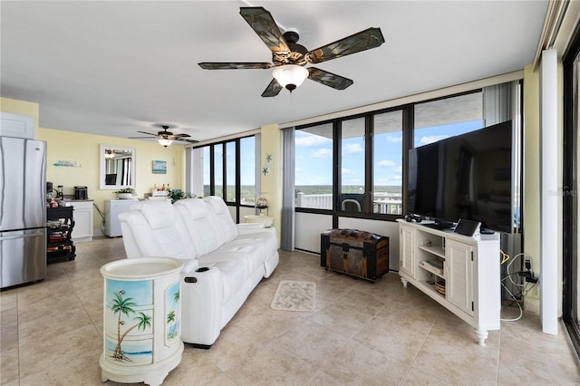 living room featuring light tile patterned floors and ceiling fan