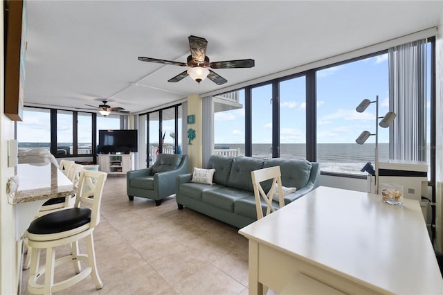 tiled living room with ceiling fan