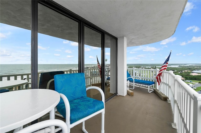 balcony with a beach view and a water view