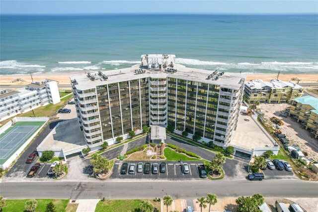 drone / aerial view with a beach view and a water view