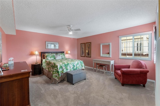 carpeted bedroom with ceiling fan and a textured ceiling