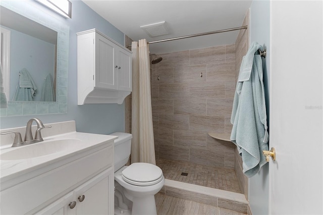 bathroom featuring vanity, a shower with curtain, and toilet