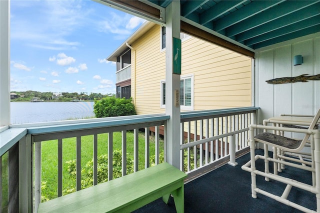 balcony featuring ceiling fan and a water view