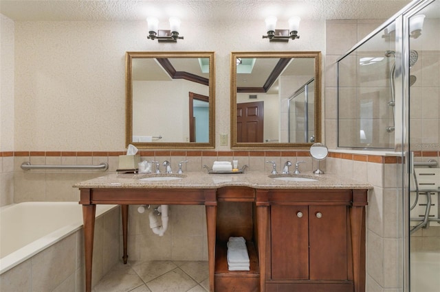 bathroom with vanity, a textured ceiling, shower with separate bathtub, tile walls, and tile patterned flooring