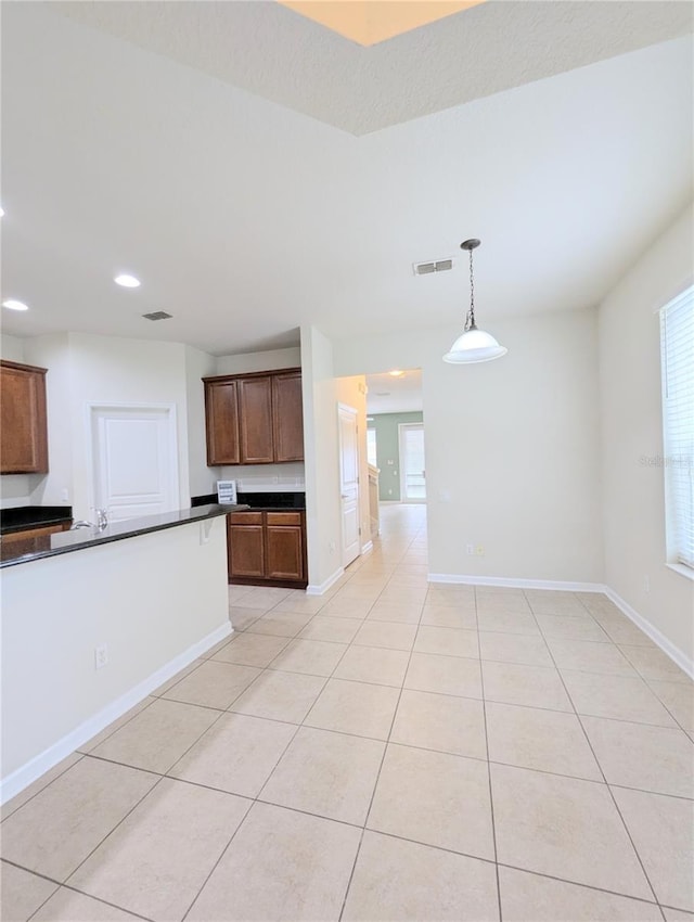 kitchen with hanging light fixtures and light tile patterned floors