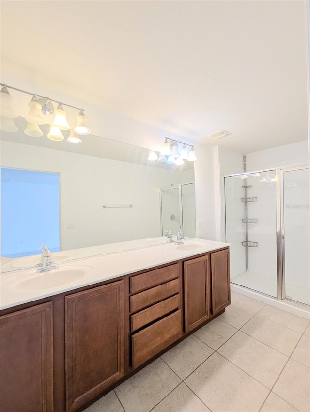 bathroom with tile patterned floors, an enclosed shower, and vanity