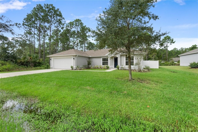 view of front of property with a garage and a front lawn