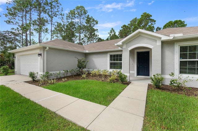 ranch-style house featuring a garage and a front yard