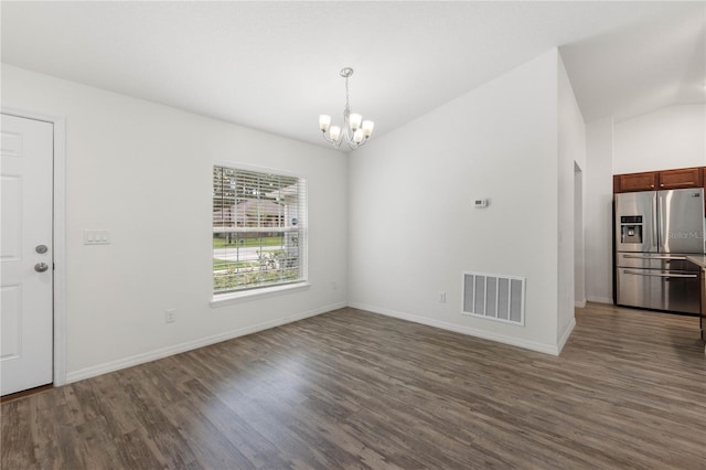 interior space with lofted ceiling, a chandelier, and dark hardwood / wood-style floors