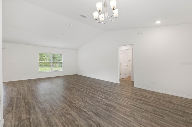 unfurnished room featuring an inviting chandelier, vaulted ceiling, and dark hardwood / wood-style flooring