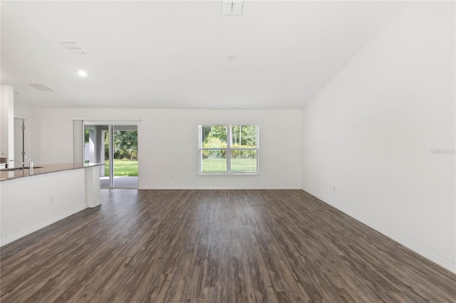 unfurnished living room featuring dark hardwood / wood-style flooring