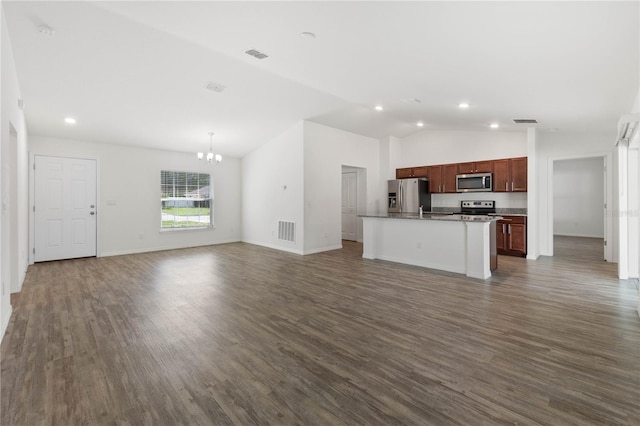 kitchen with an island with sink, a chandelier, stainless steel appliances, dark hardwood / wood-style floors, and vaulted ceiling