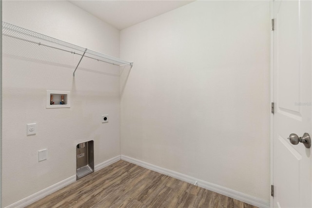 washroom with hookup for an electric dryer, hookup for a washing machine, and hardwood / wood-style floors