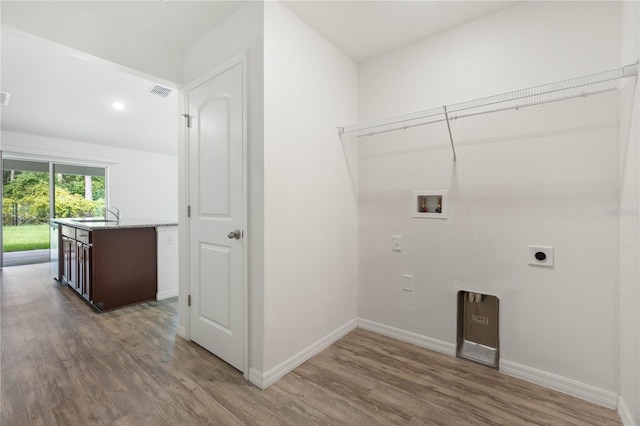 laundry room featuring dark hardwood / wood-style floors, hookup for an electric dryer, washer hookup, and sink