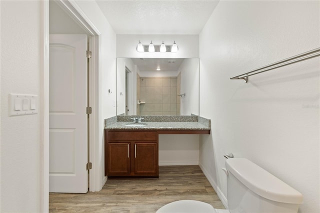 bathroom with vanity, hardwood / wood-style floors, toilet, and a textured ceiling