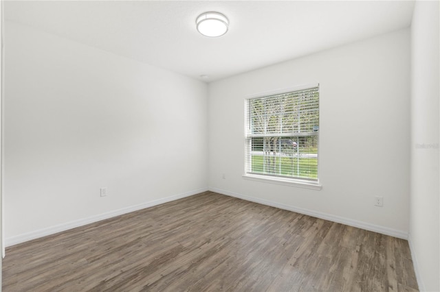 unfurnished room with hardwood / wood-style floors