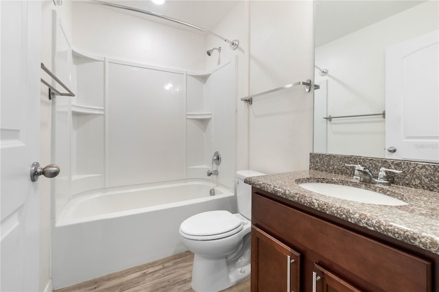 full bathroom featuring tub / shower combination, vanity, toilet, and hardwood / wood-style floors