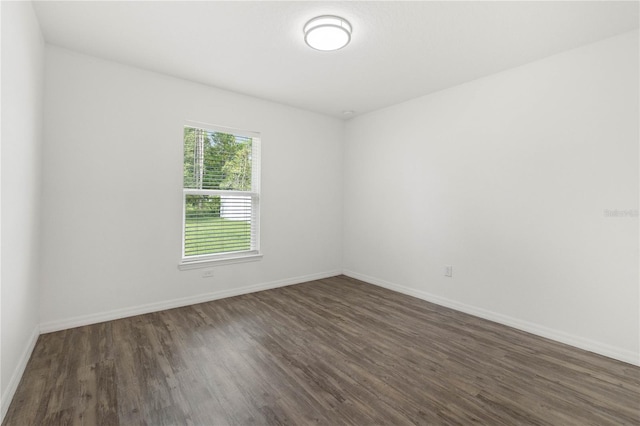 spare room with dark wood-type flooring