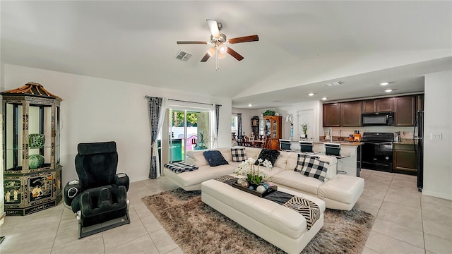 living room featuring light tile patterned floors, lofted ceiling, and ceiling fan