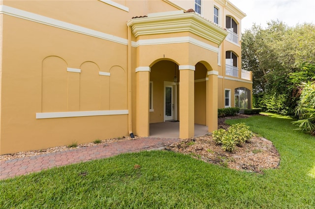 exterior space featuring a front yard and a balcony