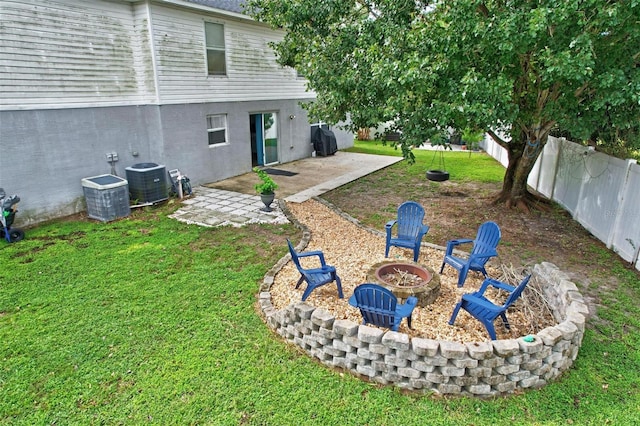 view of yard with a patio, cooling unit, and an outdoor fire pit