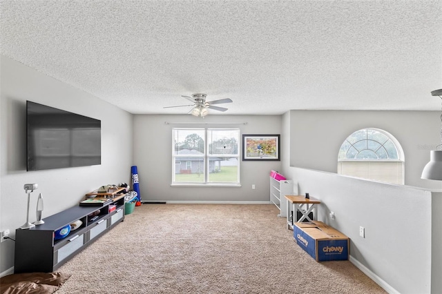 rec room with a healthy amount of sunlight, carpet, and ceiling fan