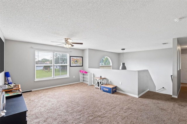 recreation room featuring a textured ceiling and carpet flooring