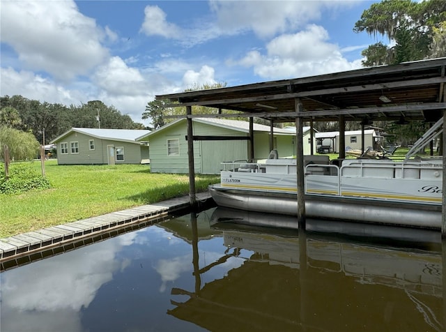 dock area with a water view and a yard