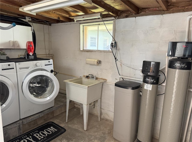 washroom with washer and dryer, laundry area, and a sink