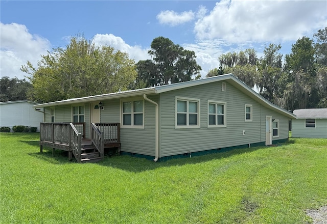 back of property featuring crawl space and a lawn