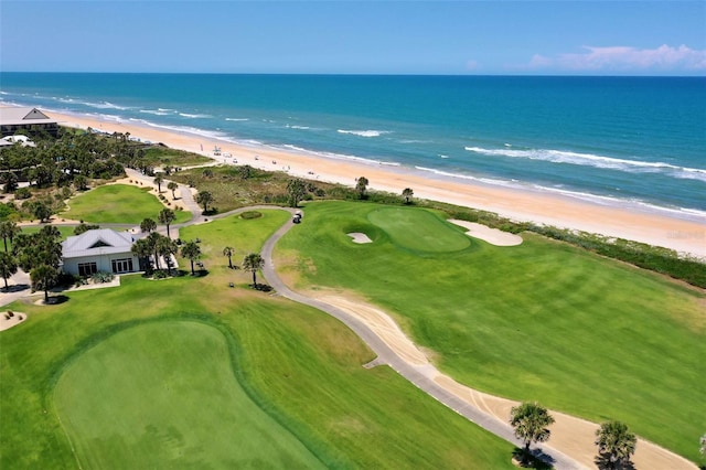 drone / aerial view featuring a water view and a beach view