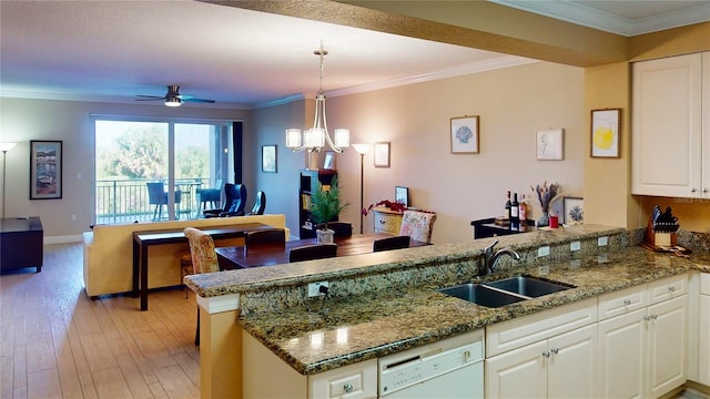 kitchen with light hardwood / wood-style floors, sink, ceiling fan with notable chandelier, white cabinets, and kitchen peninsula