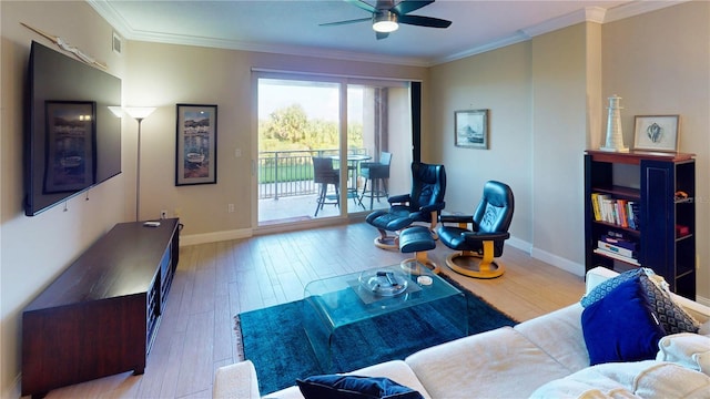 living room with light hardwood / wood-style flooring, ceiling fan, and crown molding