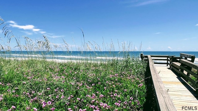 exterior space featuring a water view and a view of the beach